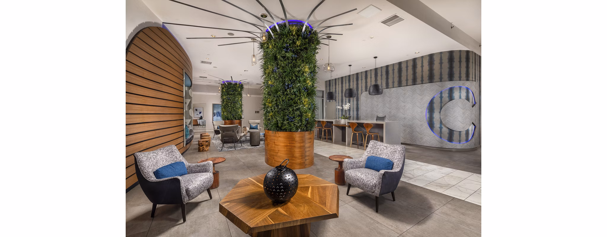 Elegant lobby featuring modern decor and seating areas at The Current Apartments, a luxury community by Greystar