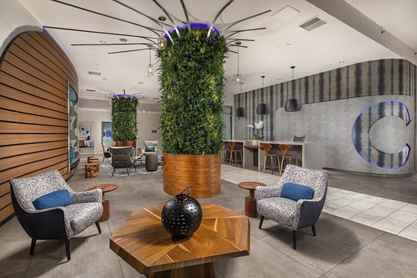 Elegant lobby featuring modern decor and seating areas at The Current Apartments, a luxury community by Greystar