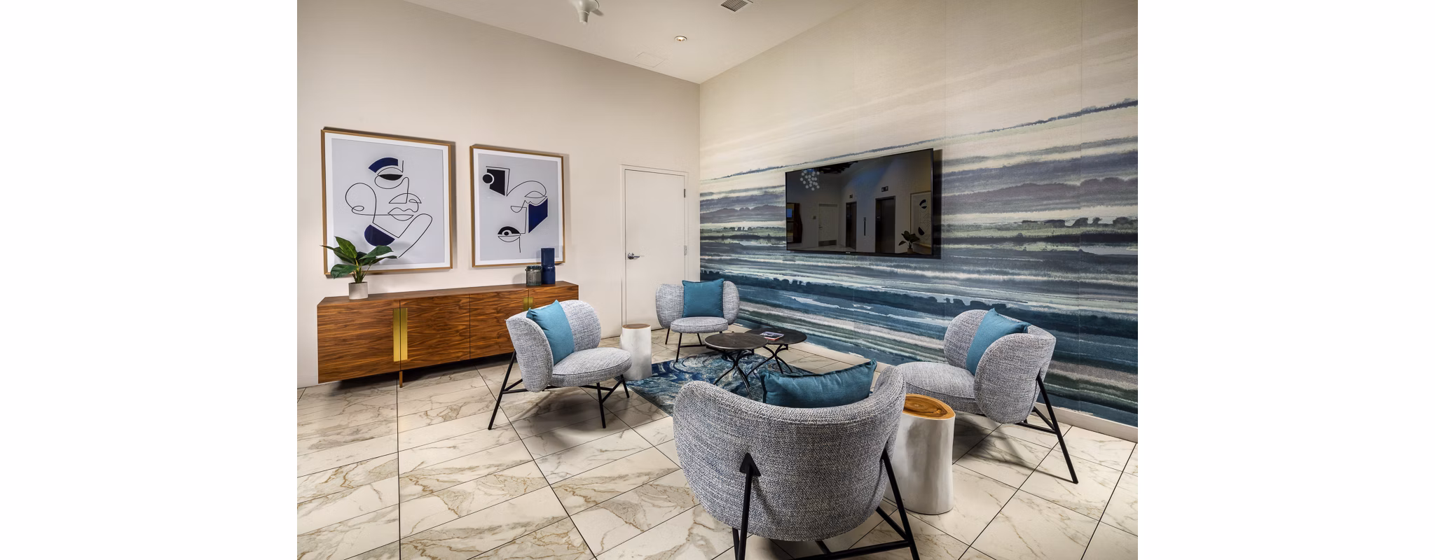 Modern lobby with sleek furnishings and contemporary lighting at The Current Apartments, a luxury Greystar property in coastal location