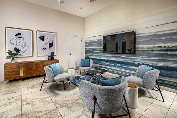 Modern lobby with sleek furnishings and contemporary lighting at The Current Apartments, a luxury Greystar property in coastal location