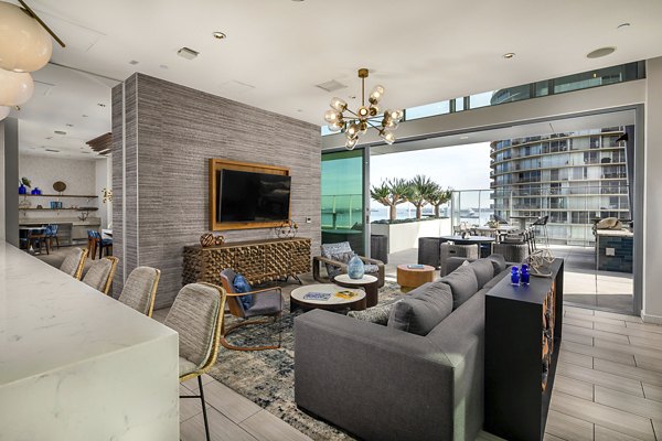 Lobby featuring sleek design and modern seating at The Current Apartments, a luxury residence by Greystar