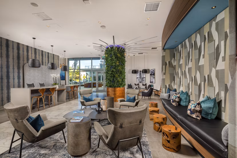 The Current Apartments: Modern lobby with contemporary seating and art deco accents in a luxury Greystar community