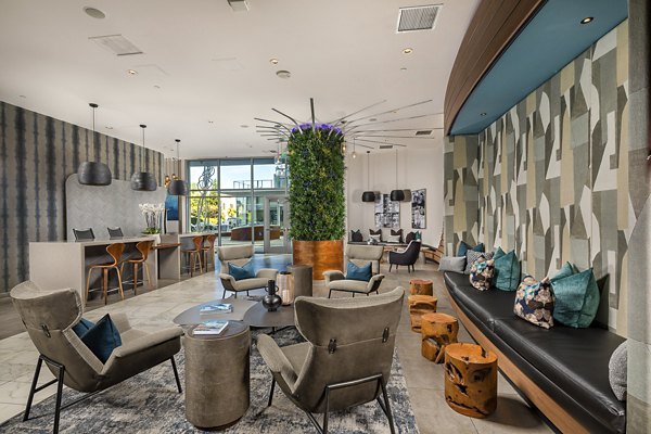 The Current Apartments: Modern lobby with contemporary seating and art deco accents in a luxury Greystar community