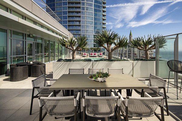 Modern outdoor patio with stylish seating at The Current Apartments, offering luxury living by Greystar in the heart of the city