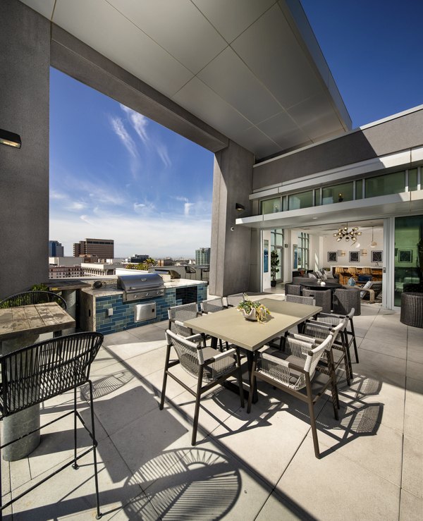 The Current Apartments: Stylish patio area with seating and greenery