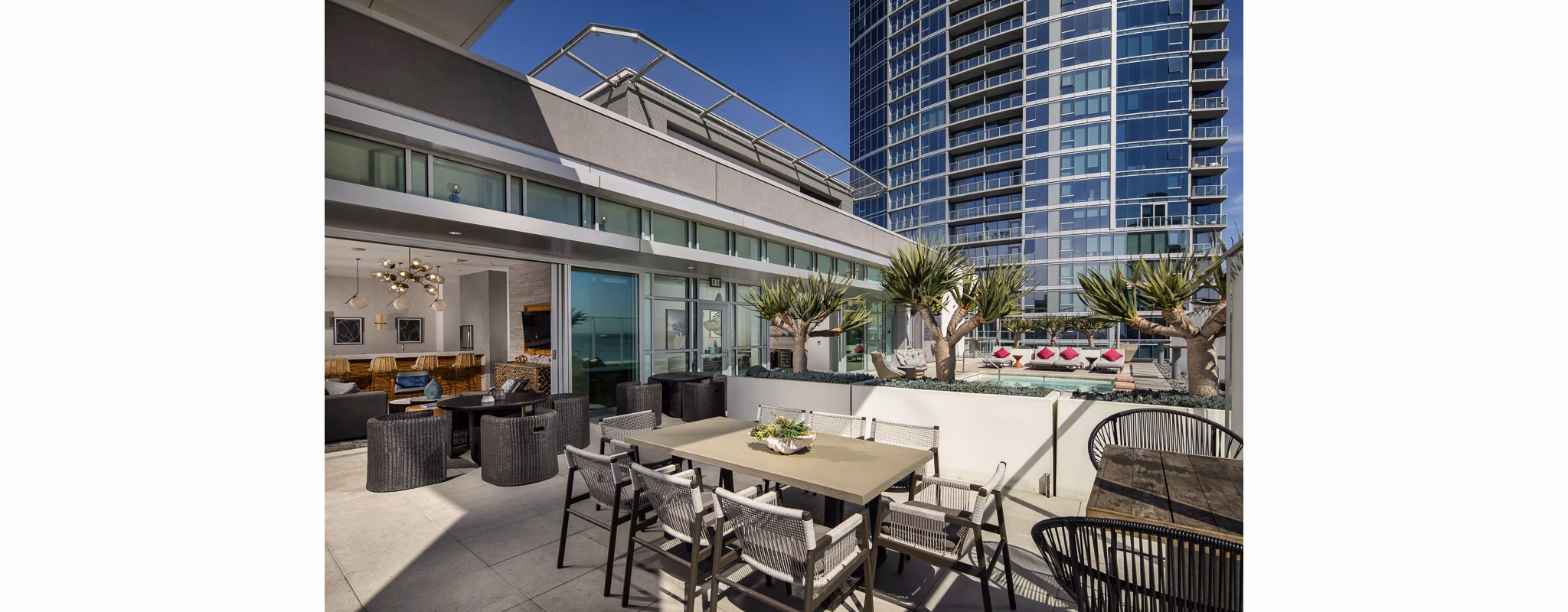 The Current Apartments: Modern patio with stylish seating and lush greenery