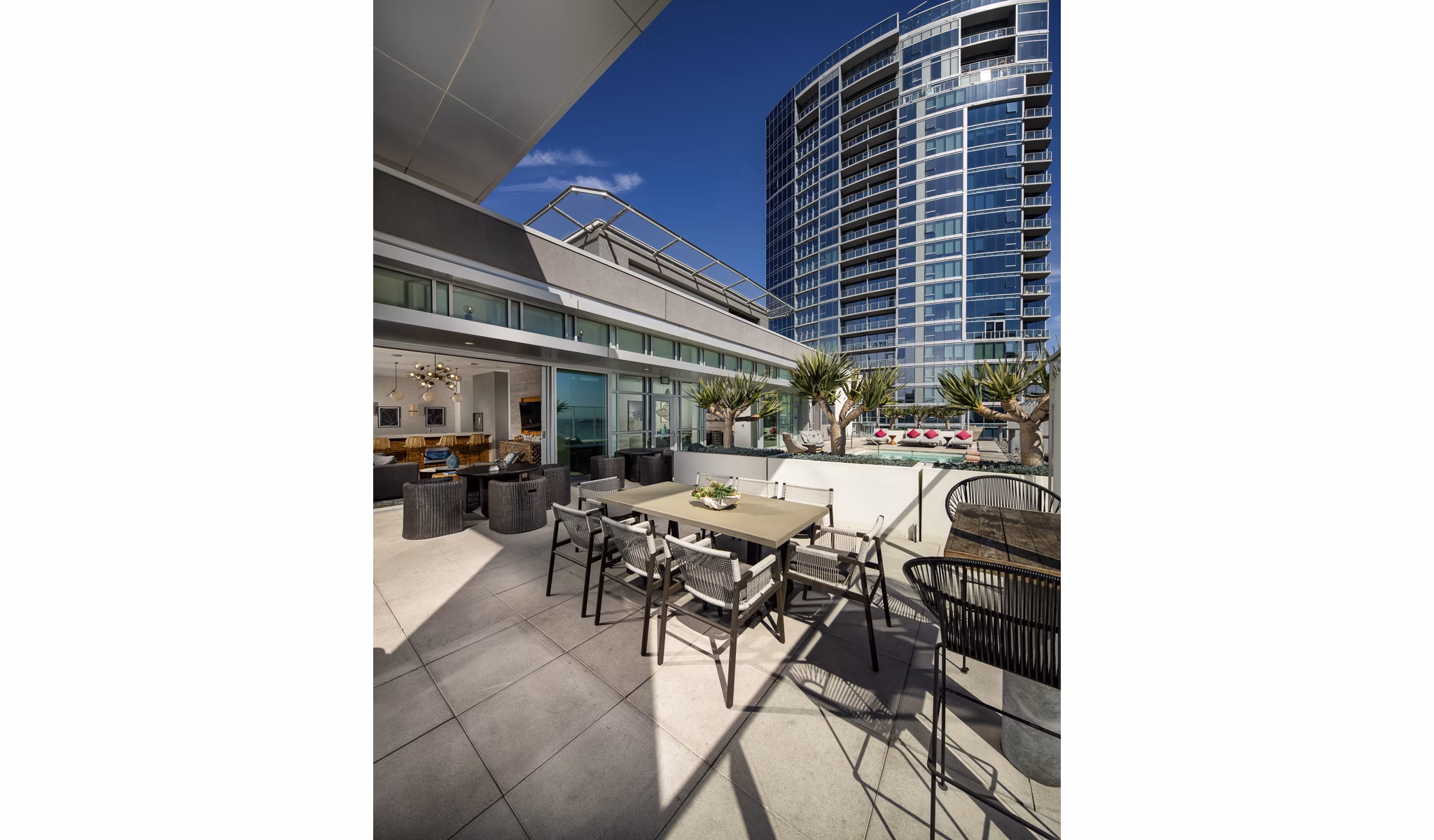 Patio with modern furniture and coastal views at The Current Apartments