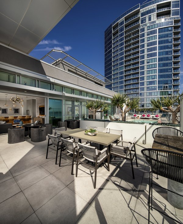 Patio with modern furniture and coastal views at The Current Apartments
