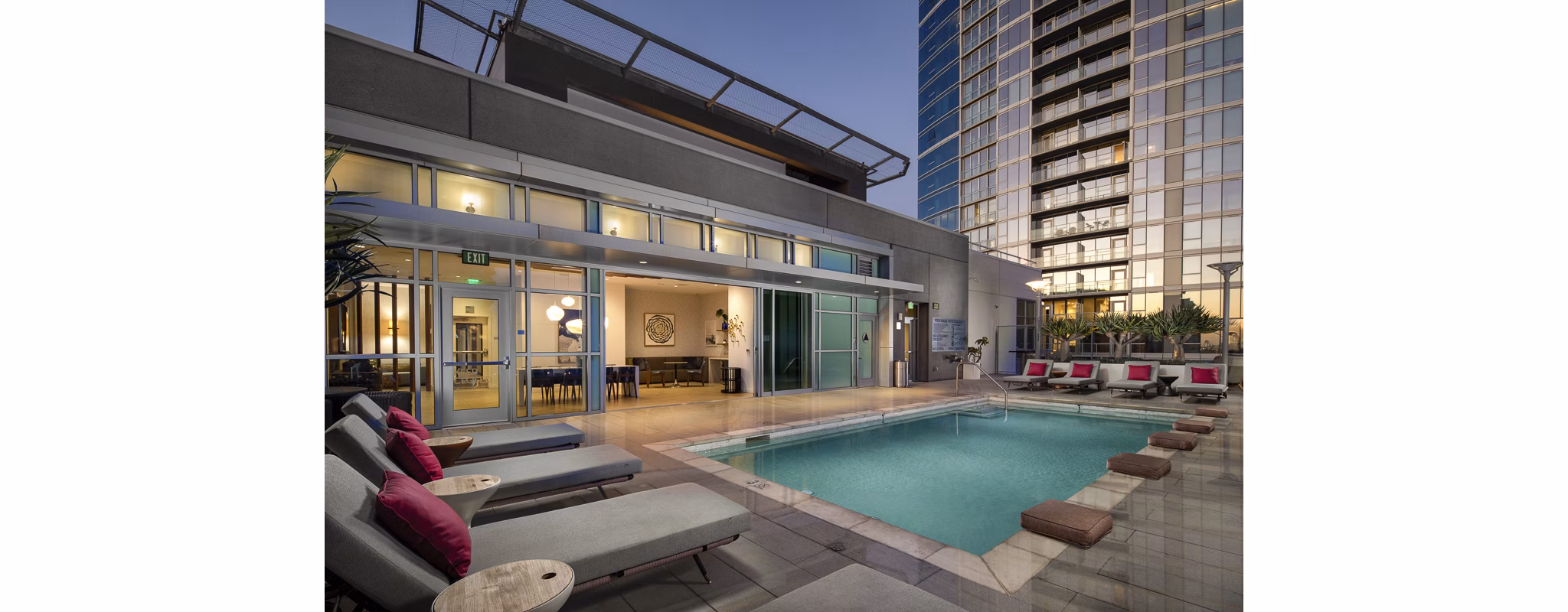 Resort-style pool with lush landscaping at The Current Apartments