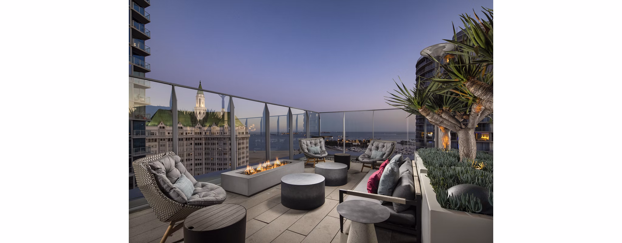 Warm outdoor fire pit with cozy seating at The Current Apartments, ideal for evening gatherings and relaxation in a tranquil setting
