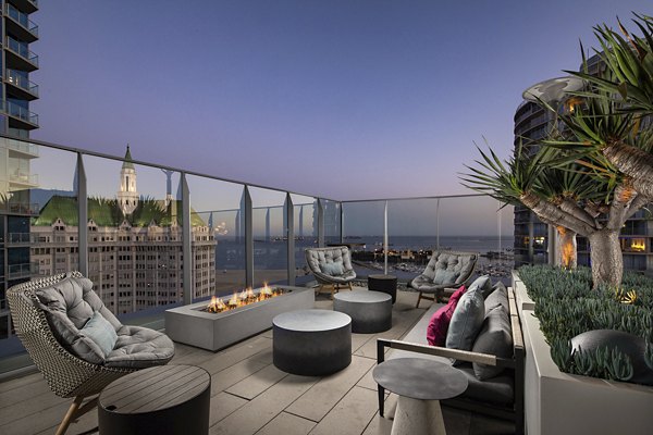 Warm outdoor fire pit with cozy seating at The Current Apartments, ideal for evening gatherings and relaxation in a tranquil setting