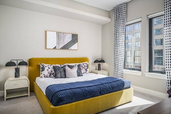 Spacious bedroom featuring contemporary design and large windows at The Ryan Apartments