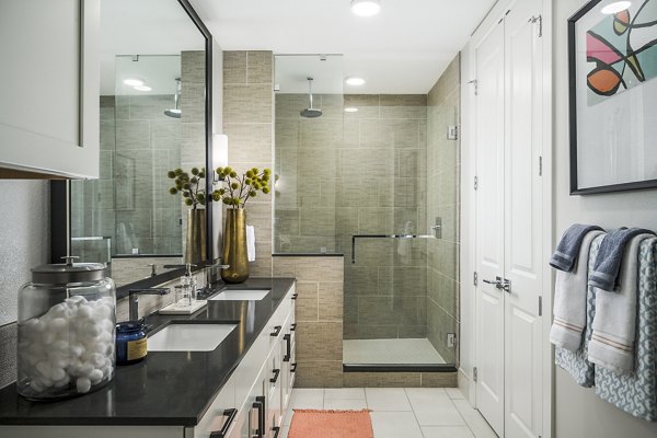 The Ryan Apartments: Modern bathroom with sleek fixtures and marble accents