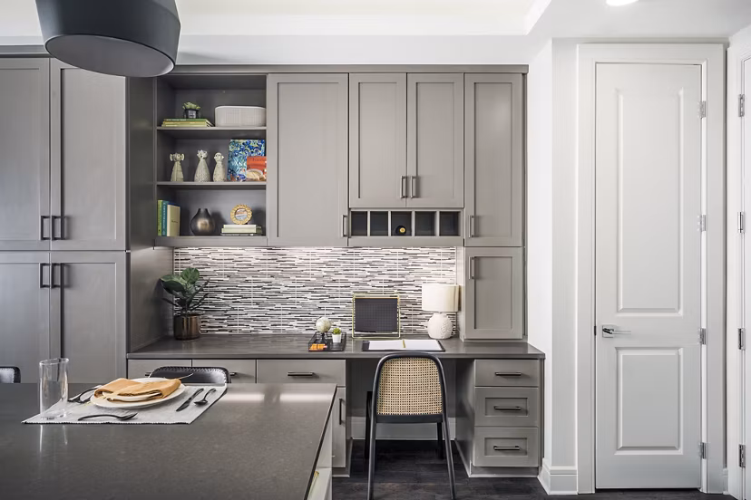 Dining room with elegant table and home office nook at The Ryan Apartments, offering stylish flexibility in a luxury setting