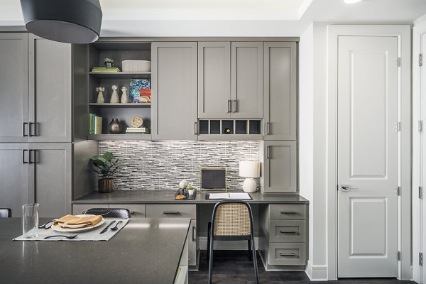 Dining room with elegant table and home office nook at The Ryan Apartments, offering stylish flexibility in a luxury setting