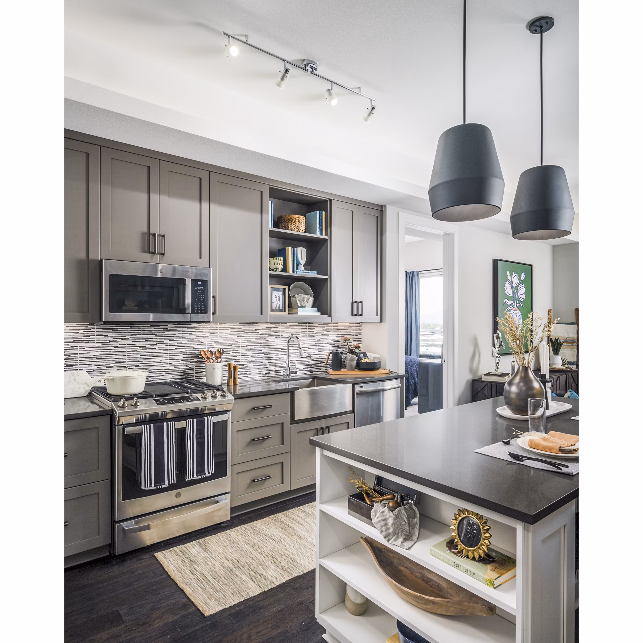 Modern kitchen with stainless steel appliances in The Ryan Apartments, a luxurious living space designed for comfort and style in a prime location