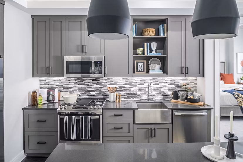 Modern kitchen featuring stainless steel appliances and granite countertops at The Ryan Apartments