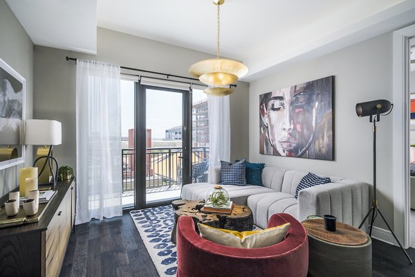 Modern living room with sleek furnishings at The Ryan Apartments, showcasing luxury living standards in a Greystar-managed community