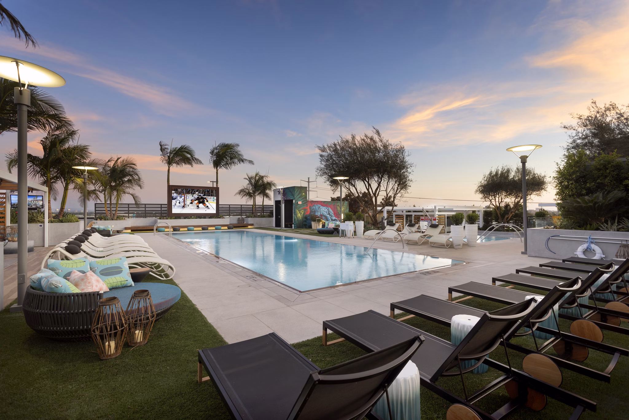 Broadstone Arden Apartments: Sunlit outdoor pool with lounge chairs and landscaping in a luxury community