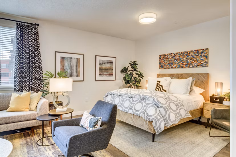 Cozy bedroom with plush bedding and modern furnishings at The Zeller Apartments