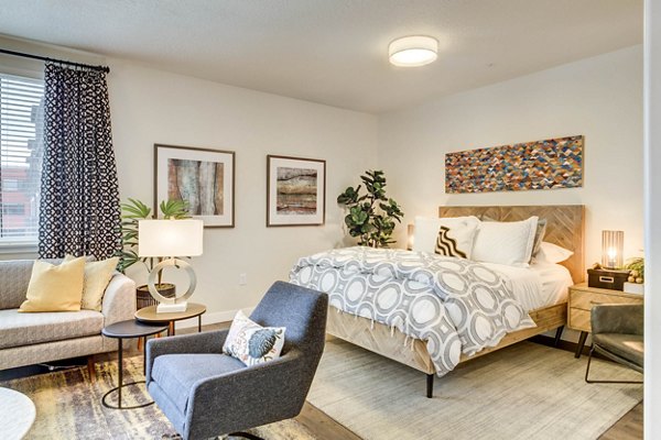 Cozy bedroom with plush bedding and modern furnishings at The Zeller Apartments