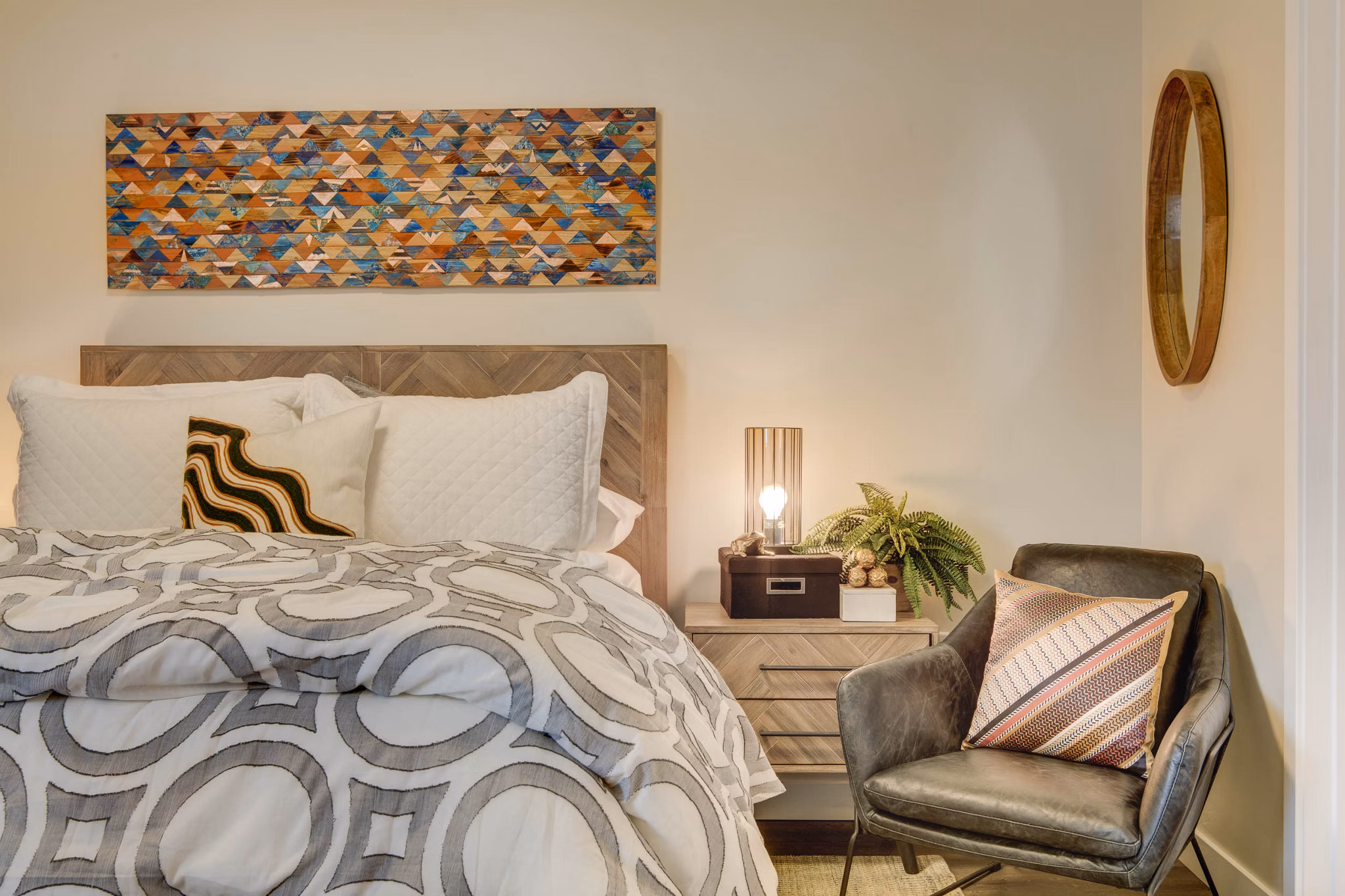 Bedroom featuring elegant dÃ©cor and large windows at The Zeller Apartments