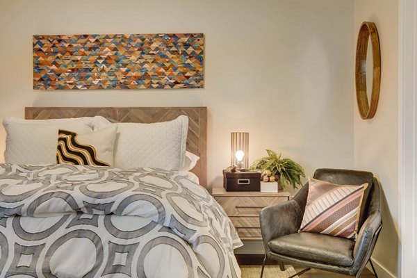Bedroom featuring elegant dÃ©cor and large windows at The Zeller Apartments