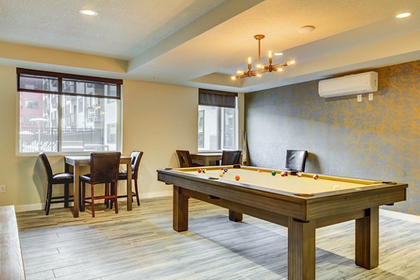 Games room featuring pool table and lounge area at The Zeller Apartments, offering luxury entertainment spaces for residents