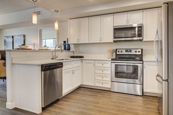 Modern kitchen with stainless steel appliances at The Zeller Apartments
