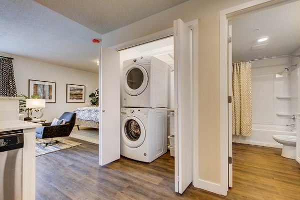 Laundry room with energy-efficient washers and dryers at The Zeller Apartments in Greystar's luxury apartment portfolio