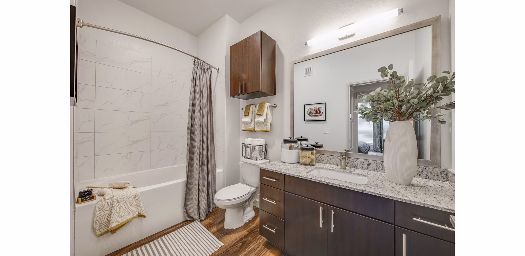 Bathroom featuring sleek fixtures and marble countertops in The Silverlake Apartments