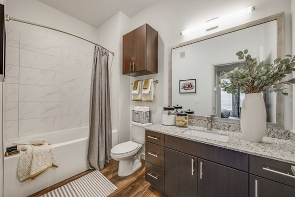 Bathroom featuring sleek fixtures and marble countertops in The Silverlake Apartments