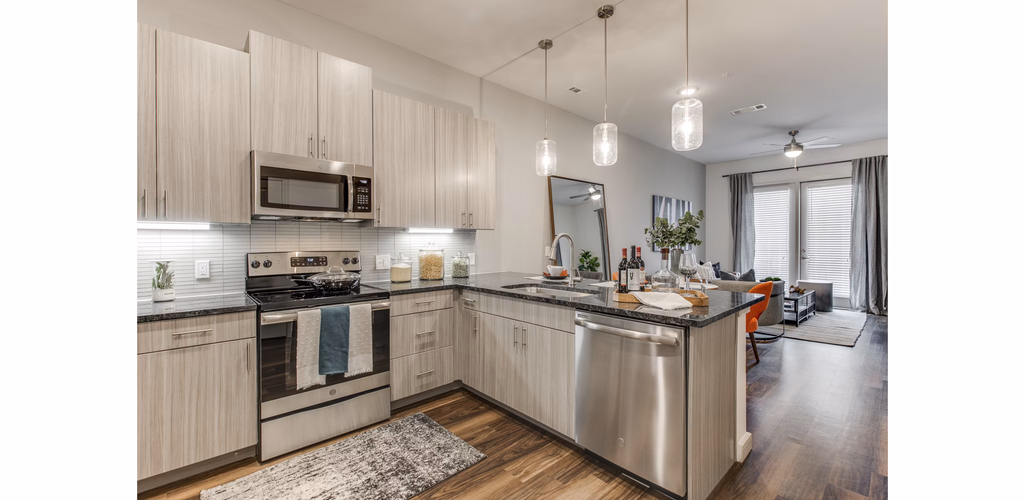 Modern kitchen with stainless steel appliances at The Silverlake Apartments, offering luxury living in an elegant residential community
