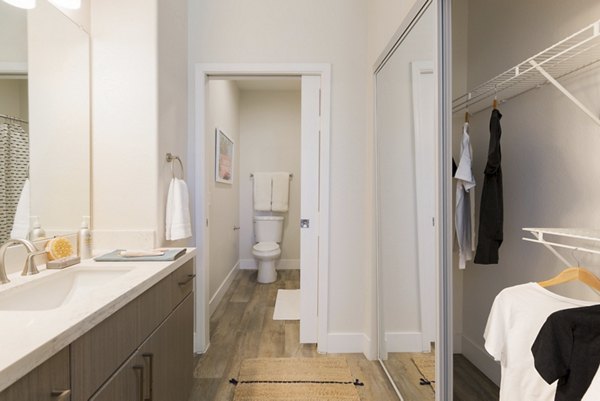 Modern bathroom featuring sleek fixtures and marble accents in ORA Apartments