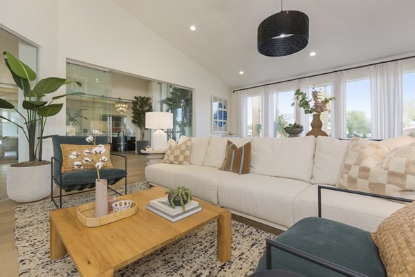 Clubhouse interior with plush seating and modern decor at ORA Apartments