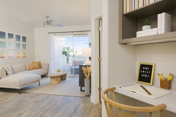 Open-concept kitchen with stainless steel appliances and granite countertops in ORA Apartments