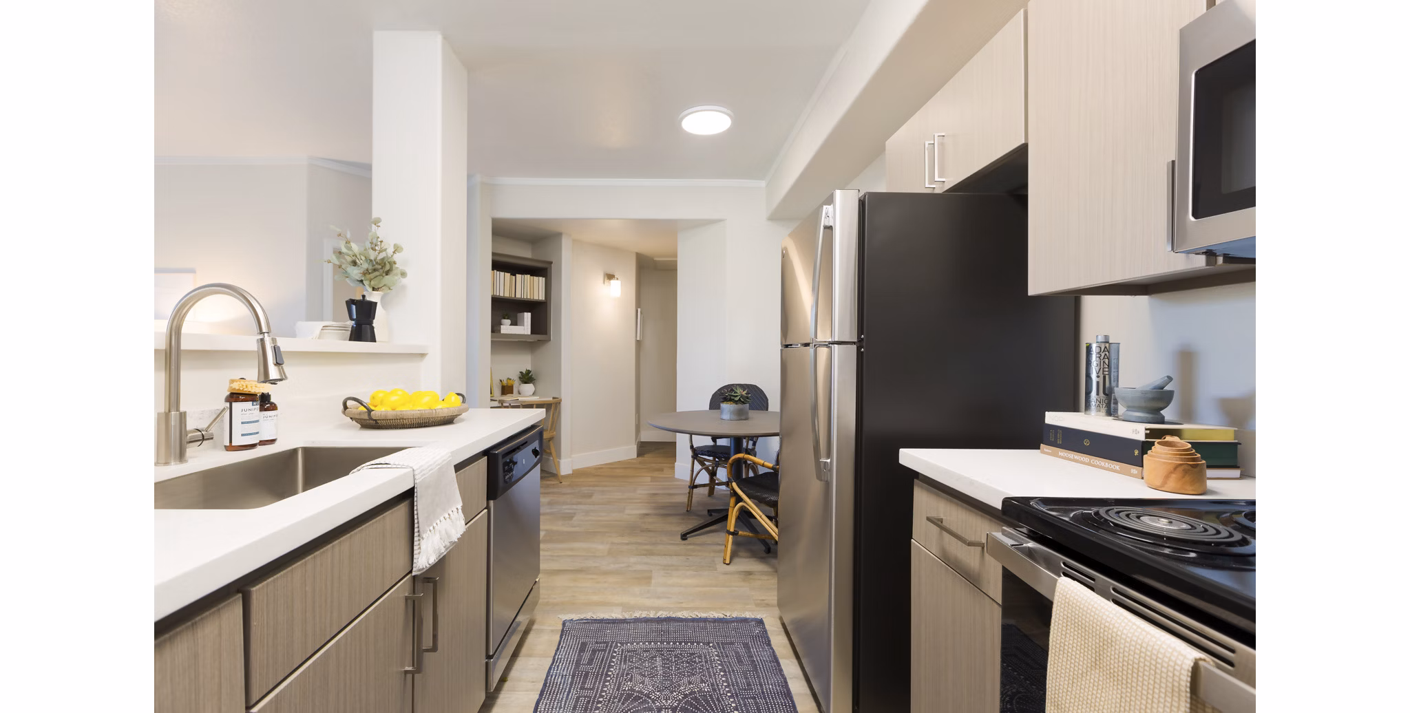 Modern kitchen with stainless steel appliances at ORA Apartments in luxury Greystar community