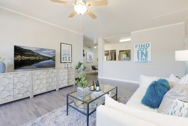 Spacious living room with modern decor and natural light in ORA Apartments, a Greystar luxury property