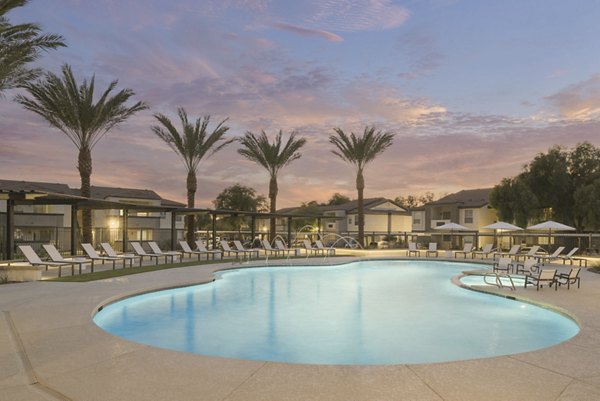 Pool area with luxurious seating at ORA Apartments, perfect for relaxation and leisure activities