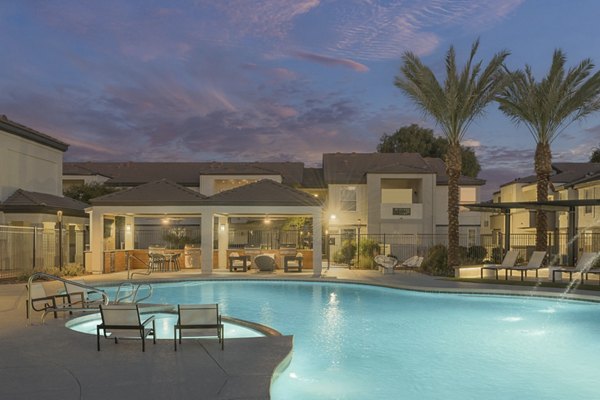ORA Apartments: Luxurious pool with cabanas and palm trees