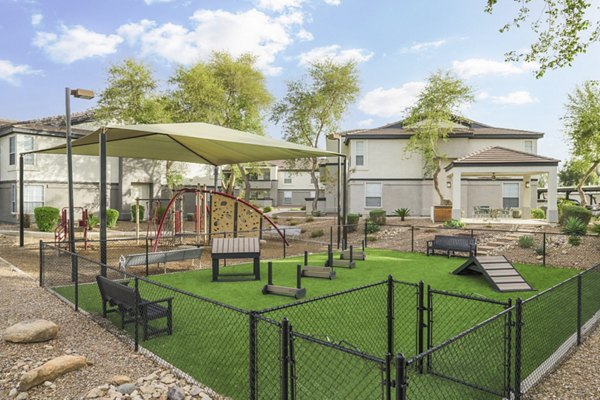 Dog-friendly park at ORA Apartments featuring agility equipment and green space for luxury pet amenities