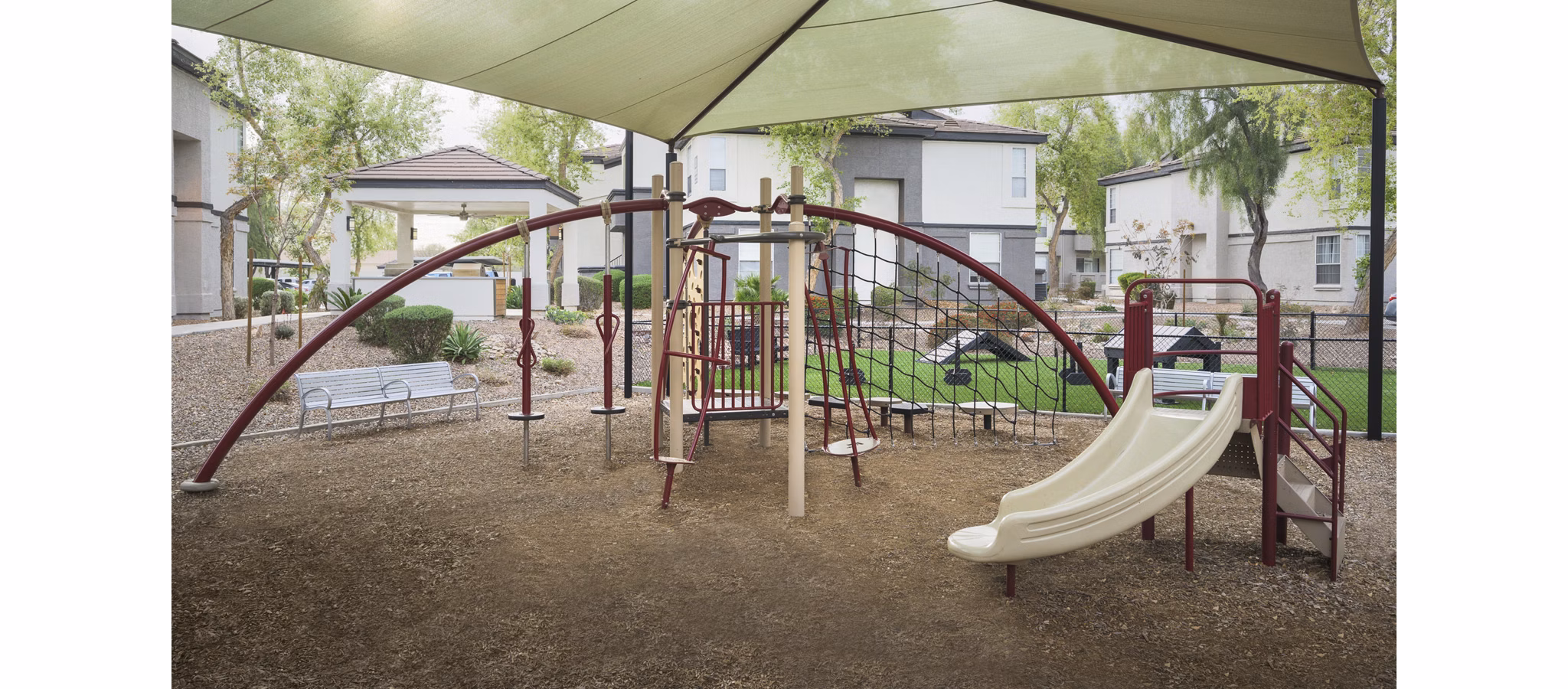 Modern playground with safe equipment at ORA Apartments, a luxury Greystar community perfect for families and kids' activities