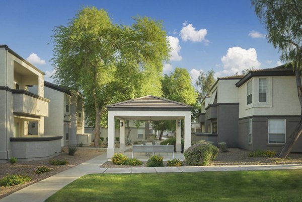 Tranquil courtyard with lush greenery at ORA Apartments, a luxury property by Greystar