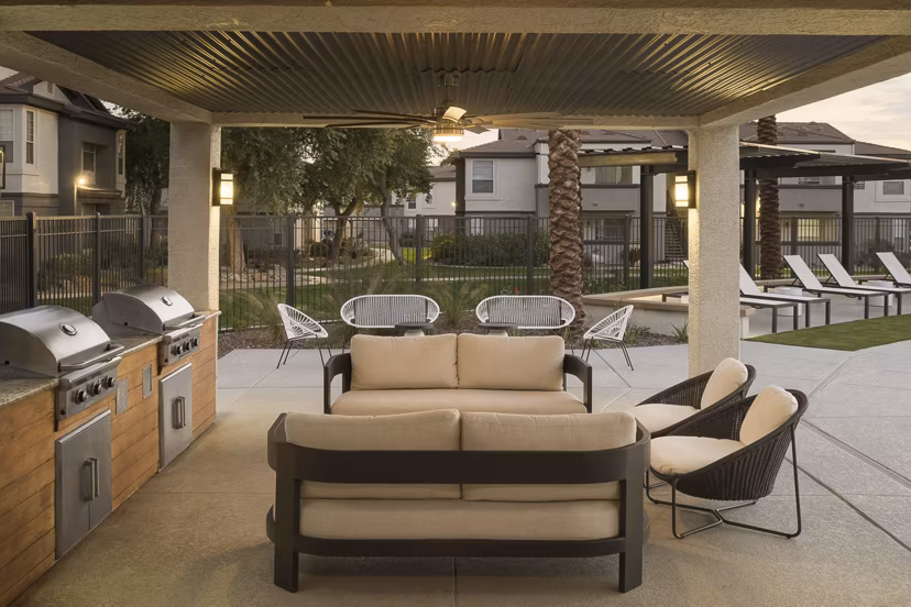 Modern grill area with outdoor seating at ORA Apartments in Greystar luxury community