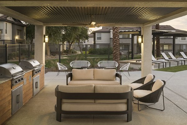 Modern grill area with outdoor seating at ORA Apartments in Greystar luxury community