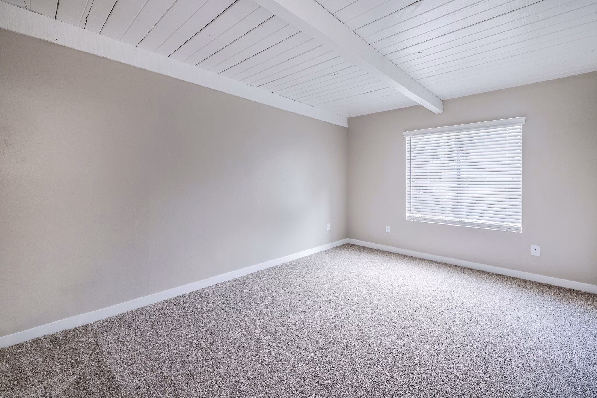 Bedroom with modern decor and natural light at Lexington Townhomes Apartments, a Greystar luxury community