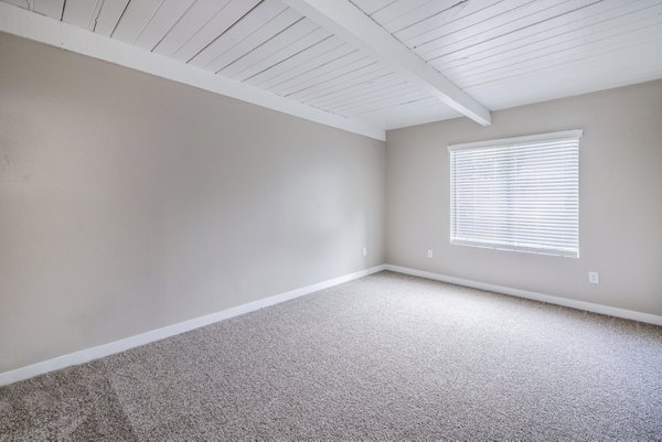 Bedroom with modern decor and natural light at Lexington Townhomes Apartments, a Greystar luxury community