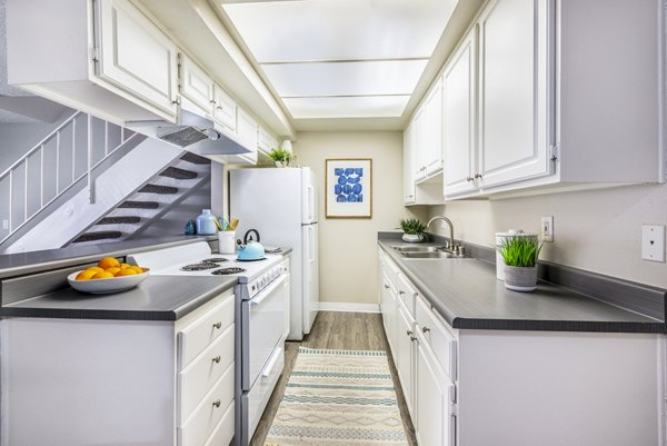 Modern kitchen with sleek appliances and granite countertops at Lexington Townhomes Apartments