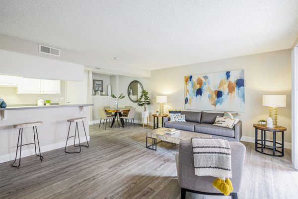Living room featuring modern design and cozy seating in Lexington Townhomes Apartments, perfect for relaxation and entertainment