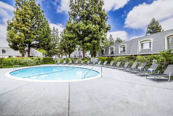 Inviting outdoor pool at Lexington Townhomes Apartments, perfect for relaxation with landscaped surroundings and comfortable seating areas